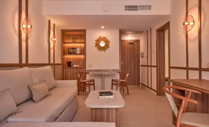 Moderne woonkamer van een One Bedroom Swim Up Suite in Zafiro Can Picafort met zithoek, eettafel en kitchenette.